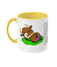 Load image into Gallery viewer, A brown bull with big horns reclining on a patch of grass wearing pink briefs.
