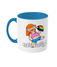 Load image into Gallery viewer, A non binary ginger person with long hair and a a moustache wearing a crop top and shorts and performing fanography with a Pride Progression flag coloured fan.
