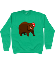 Load image into Gallery viewer, Big brown bear with red pants on his head on a green sweater
