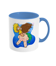 Load image into Gallery viewer, Blond bearded gay mermen being rescued underwater design on a mug
