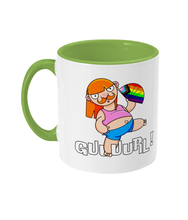 Load image into Gallery viewer, A non binary ginger person with long hair and a a moustache wearing a crop top and shorts and performing fanography with a Pride Progression flag coloured fan.
